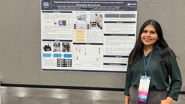 Cynthia Cortes at her poster in SACNAS